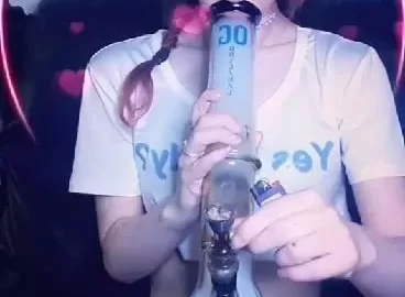 Petite white girl with braids smokes bong in bedroom