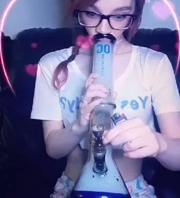 Petite white girl with braids smokes bong in bedroom