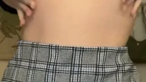 Brunette girl plays with her tits in plaid skirt