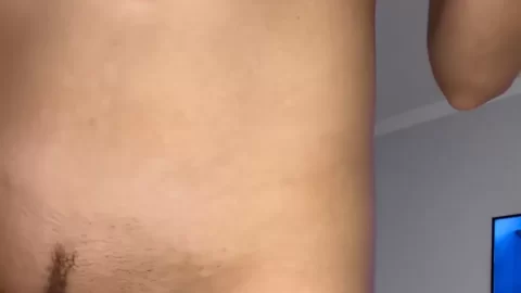 Brunette with big tits adjusts clothing in bedroom