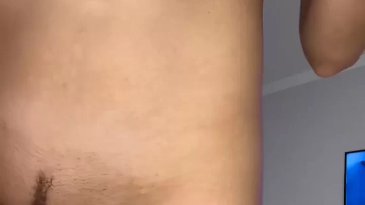 Brunette with big tits adjusts clothing in bedroom
