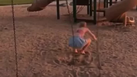 Blonde teen on outdoor swing set