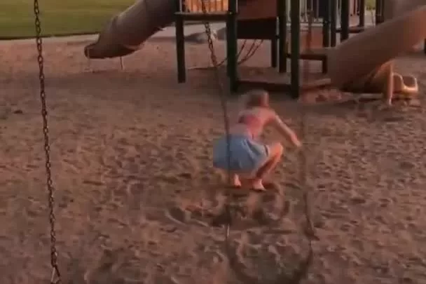 Blonde teen on outdoor swing set