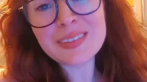 Redhead girl poses in bedroom