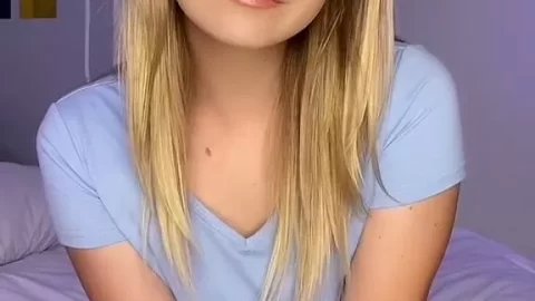 Blonde Teen Talks to Camera on Purple Bed