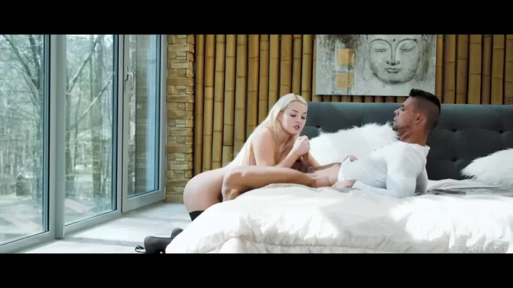 Blonde and black-haired girls with guy in bedroom