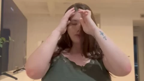 Brunette with big tits poses and dances indoors
