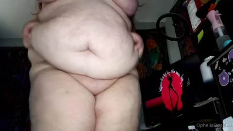 Brunette Plus-Size Woman Exposes Stomach Rolls