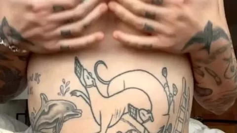 curvy brunette with tattoos exposes breasts