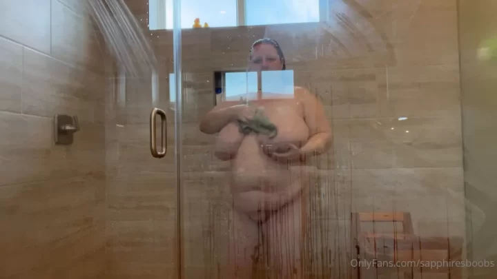 Brunette with big tits showers and soaps up
