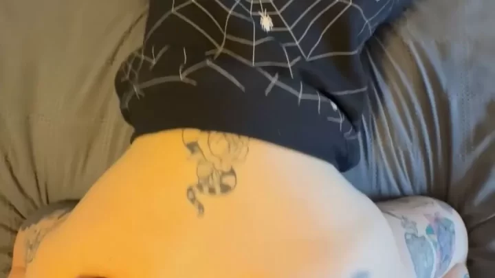 Slim white girl with dark ponytail and tattoos exposes butt