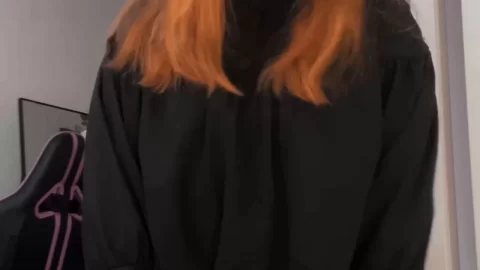 Redhead girl with tattoos poses and touches herself