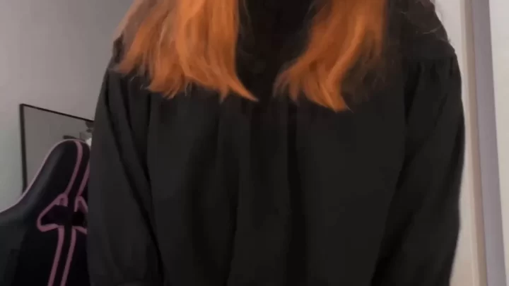 Redhead girl with tattoos poses and touches herself