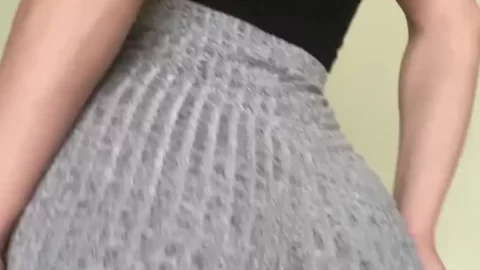 Brunette bends over, shows butt