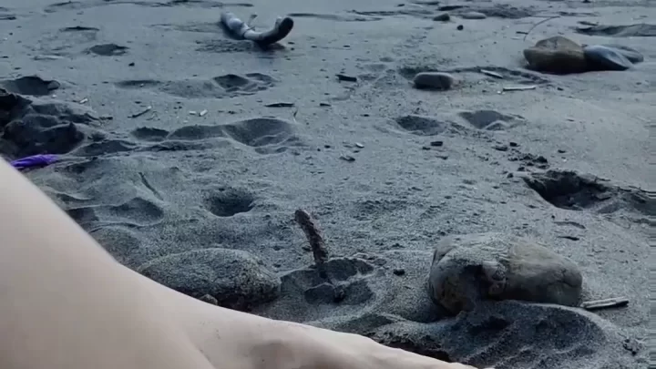 Slim 20s girl with bare feet on beach