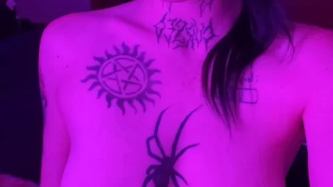 Tattooed girl in purple light