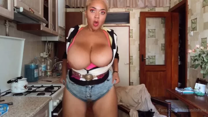 Blonde woman in bunny ears fucks herself in kitchen
