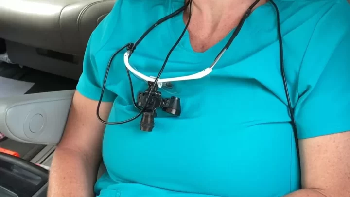 MILF with brown bun and dental loupes fucks herself with vibrator