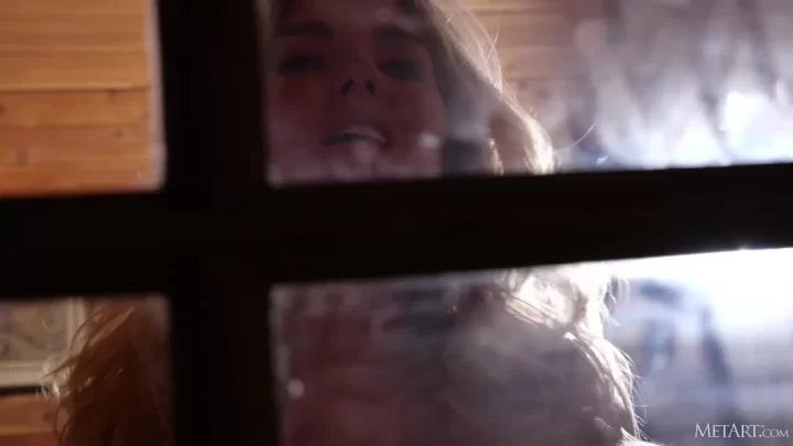 Blonde girl gets cozy by the fireplace