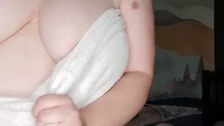 Mature brunette with big tits wraps towel, touches herself