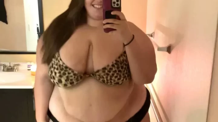 Brunette with big breasts takes selfie in bathroom