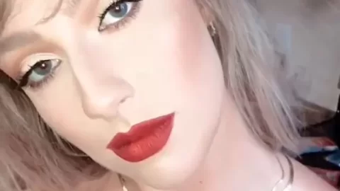 Blonde girl applies makeup, poses nude