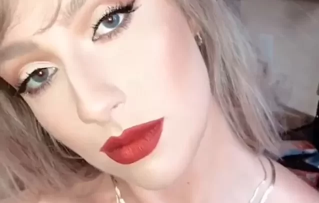 Blonde girl applies makeup, poses nude