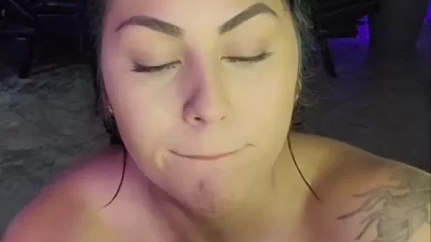 White girl with slicked back hair uses toy on couch