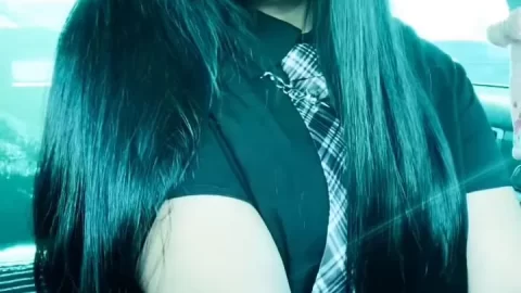 Teen girl with black hair and tattoos fucks herself in a car