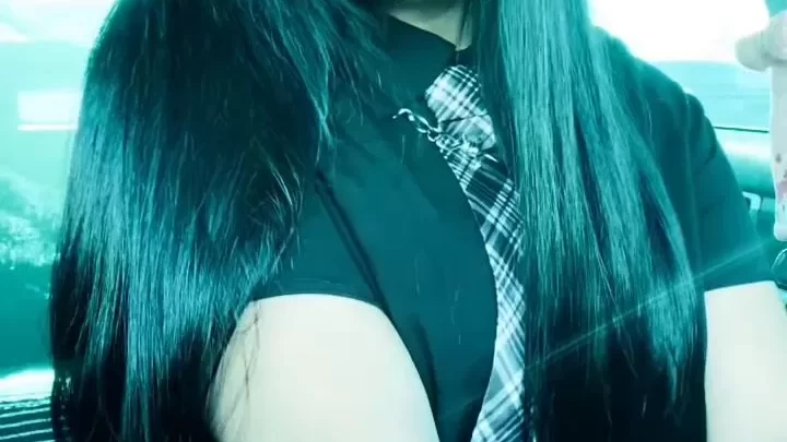 Teen girl with black hair and tattoos fucks herself in a car