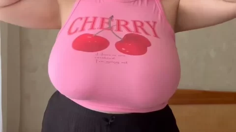 Redhead with tattoos fucks herself on bed