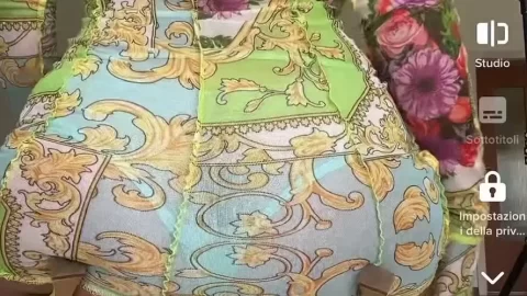 Brunette girl in colorful dress fucks herself