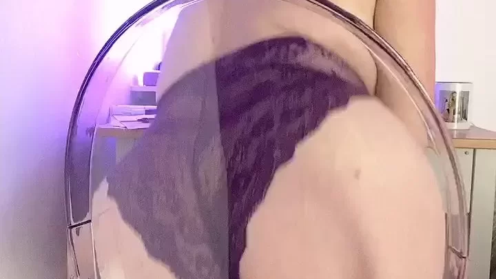 Blonde girl leans over chair, shows off butt