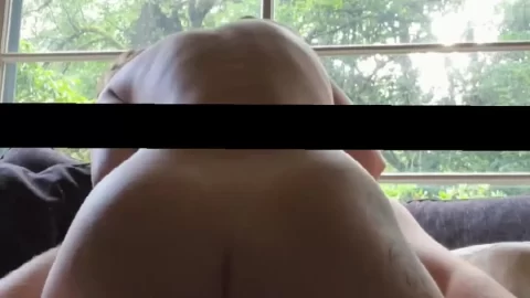 Blonde girl bent over on couch
