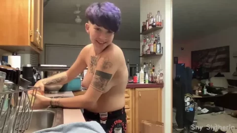 Asian guy with tattoos cooks and talks to camera