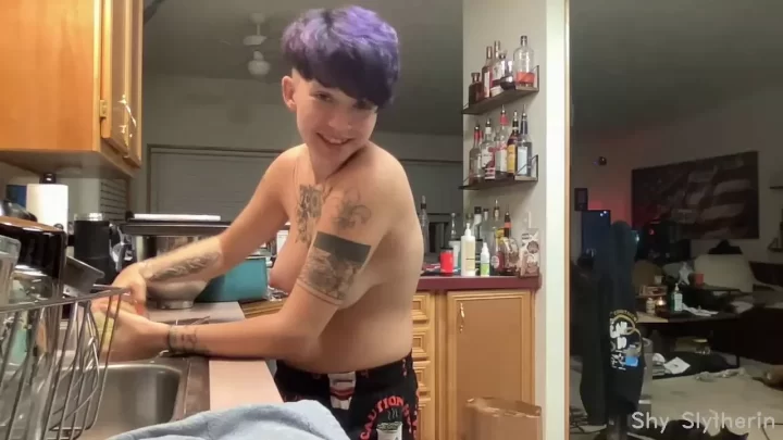 Asian guy with tattoos cooks and talks to camera