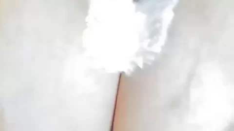 Brunette with big tits exposes breasts, plays with cream