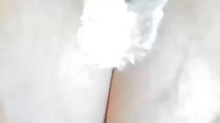 Brunette with big tits exposes breasts, plays with cream