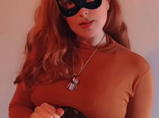 Redhead in black cat mask fucks with toy