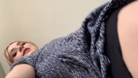 Blonde bends over, shows cleavage