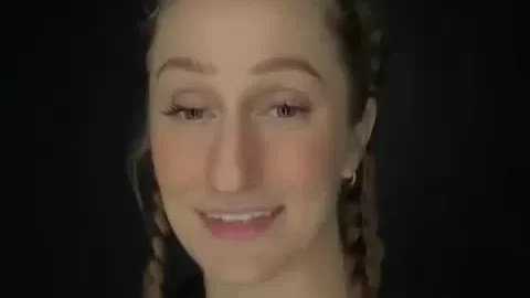 Blonde girl with braids and tattoos takes selfie