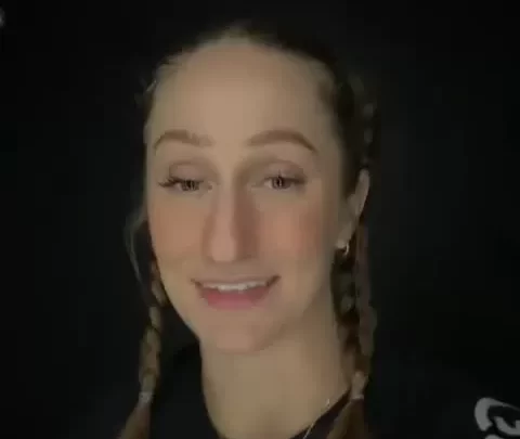 Blonde girl with braids and tattoos takes selfie
