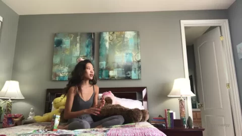Asian Girl Talks and Plays with Teddy Bear