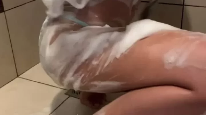 Tattooed brunette gets dirty in shower
