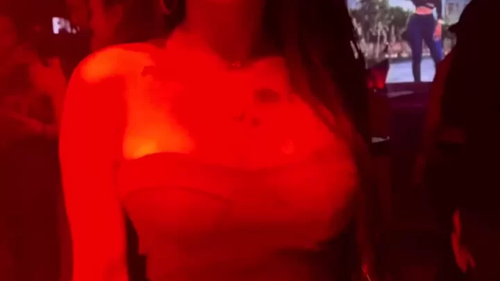 Asian girl with tattoos dances and smiles