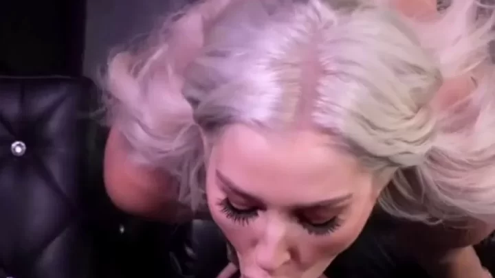 Blonde girl plays with dildo on couch