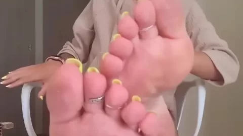 Slim White Girl with Tattoos Plays with Her Feet