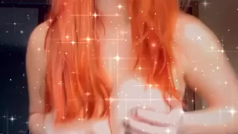 Redhead girl plays with her breasts