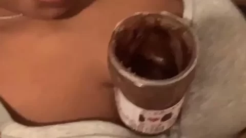 Latina girl eats chocolate spread off her tits