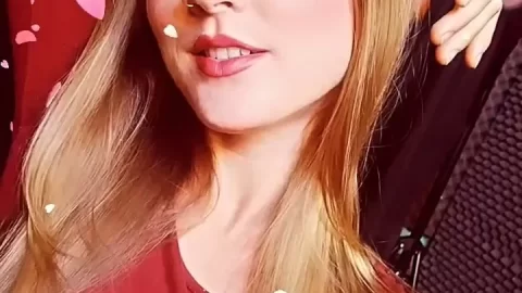 Blonde teen girl winks, poses with heart confetti